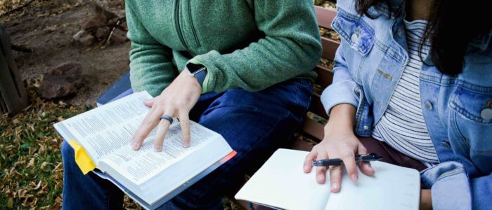 man and woman reading Bible together