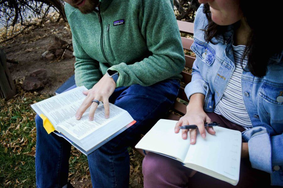 man and woman reading Bible together