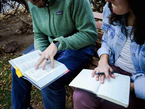 man and woman reading Bible together